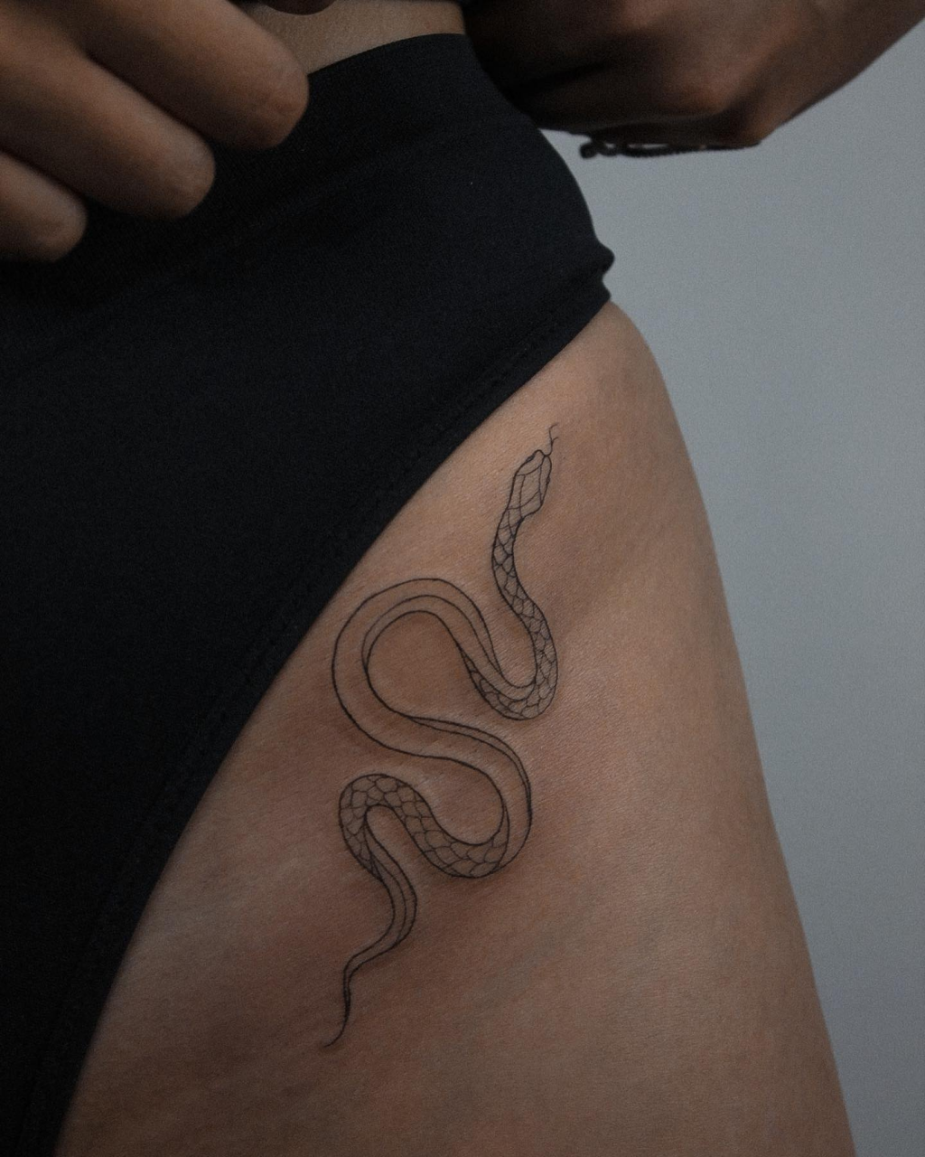 Snake tattoo on the hip