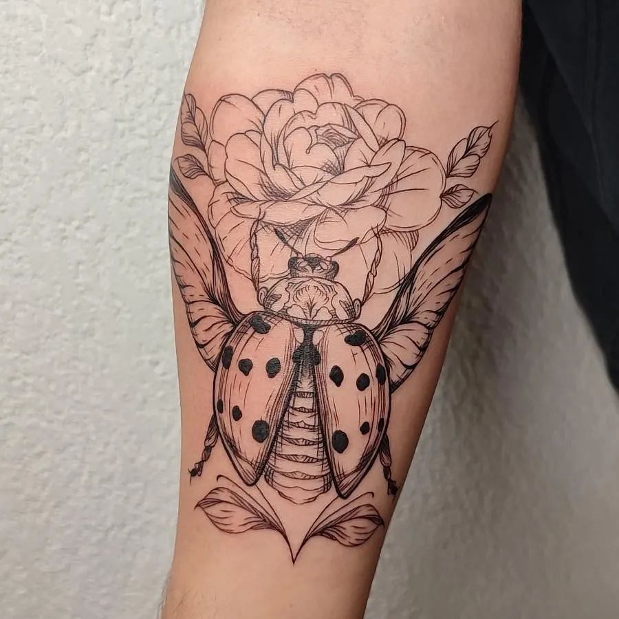 Ladybug with a flower tattoo