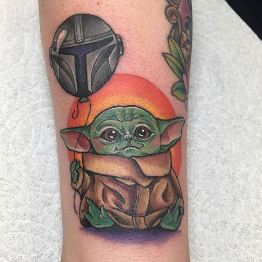 Baby Yoda with other elements This design is perfect for those who want a tattoo that represents the character in a more unique way. You can choose to include elements such as the Millennium Falcon, lightsabers, or other stuff from the series.