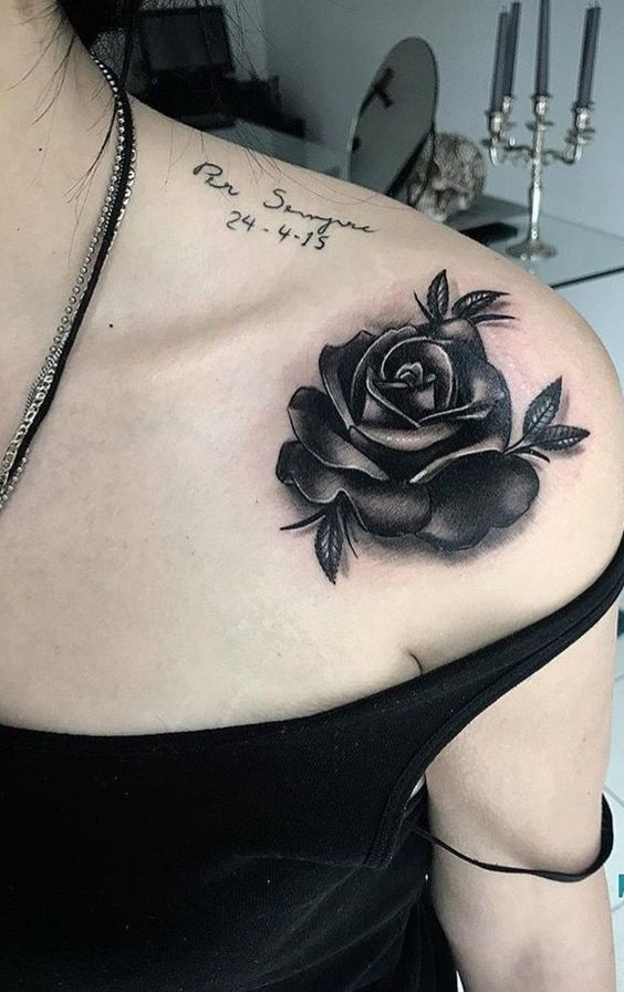 Black rose tattoo on a woman's shoulder