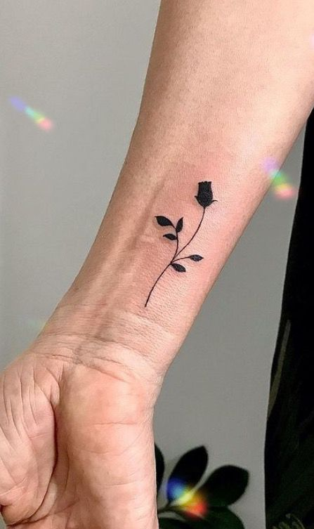 Black rose tattoo on the wrist