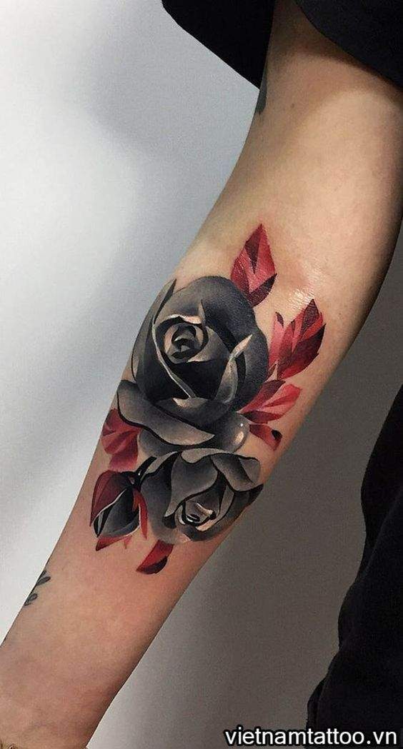 Black rose tattoo on the inner forearm