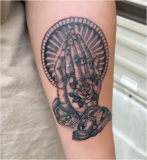 Tattoo with praying hands