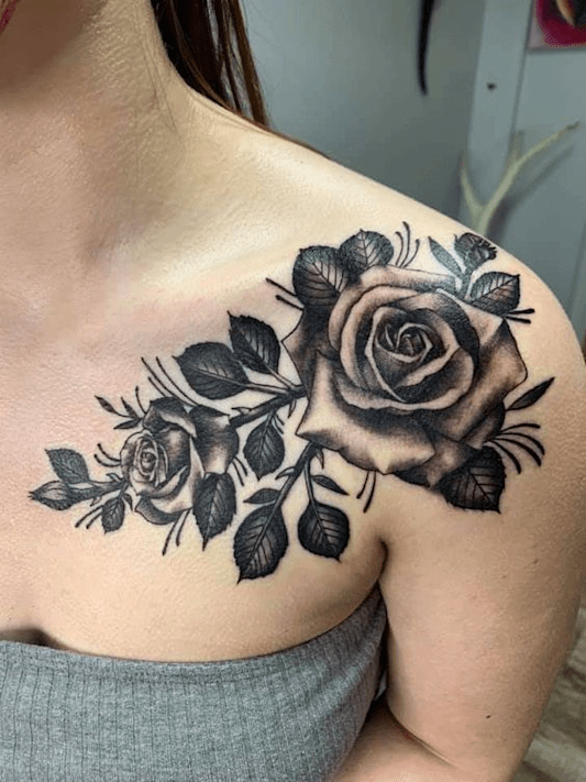Black rose tattoo on a woman's shoulder