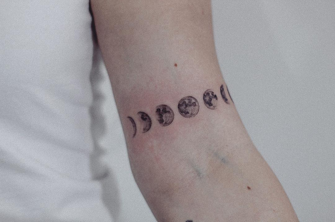 Full moon tattoo on the inner arm.