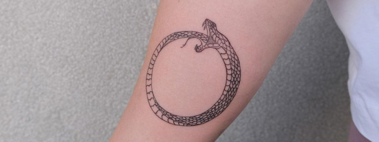 Explore the Ouroboros tattoo's eternal cycles and spiritual significance, from ancient mythology to modern tattoo art.