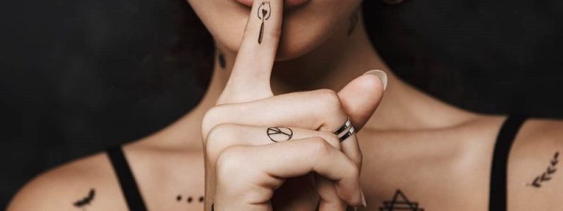 R tattoo on finger